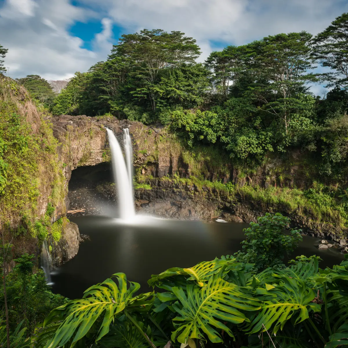 a large waterfall in a forest
