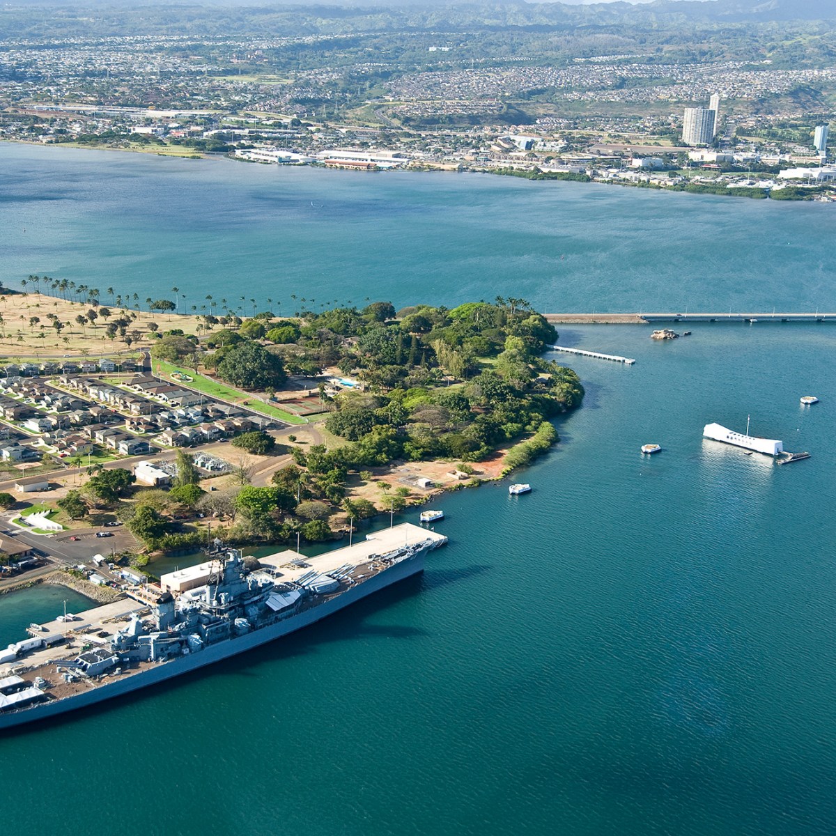 a large body of water with a city in the background