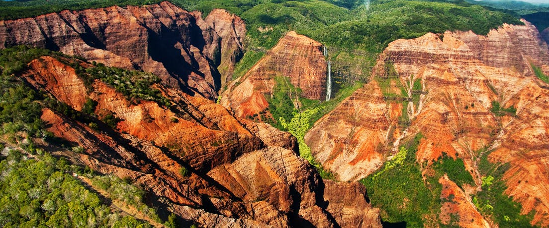 journey-waimea a canyon with a mountain in the background