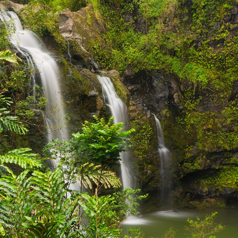 a large waterfall over a body of water