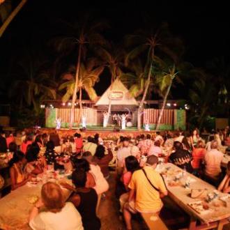 a group of people sitting at a table in front of a crowd