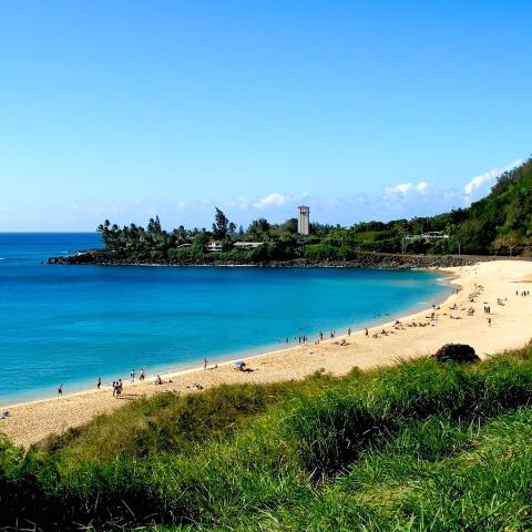 a sandy beach next to a body of water